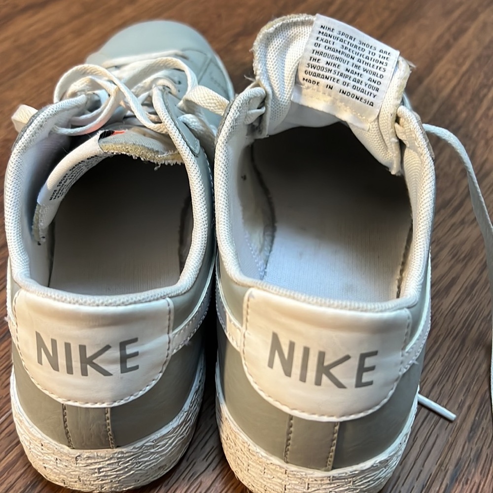 Gray and white Nike court shoes.